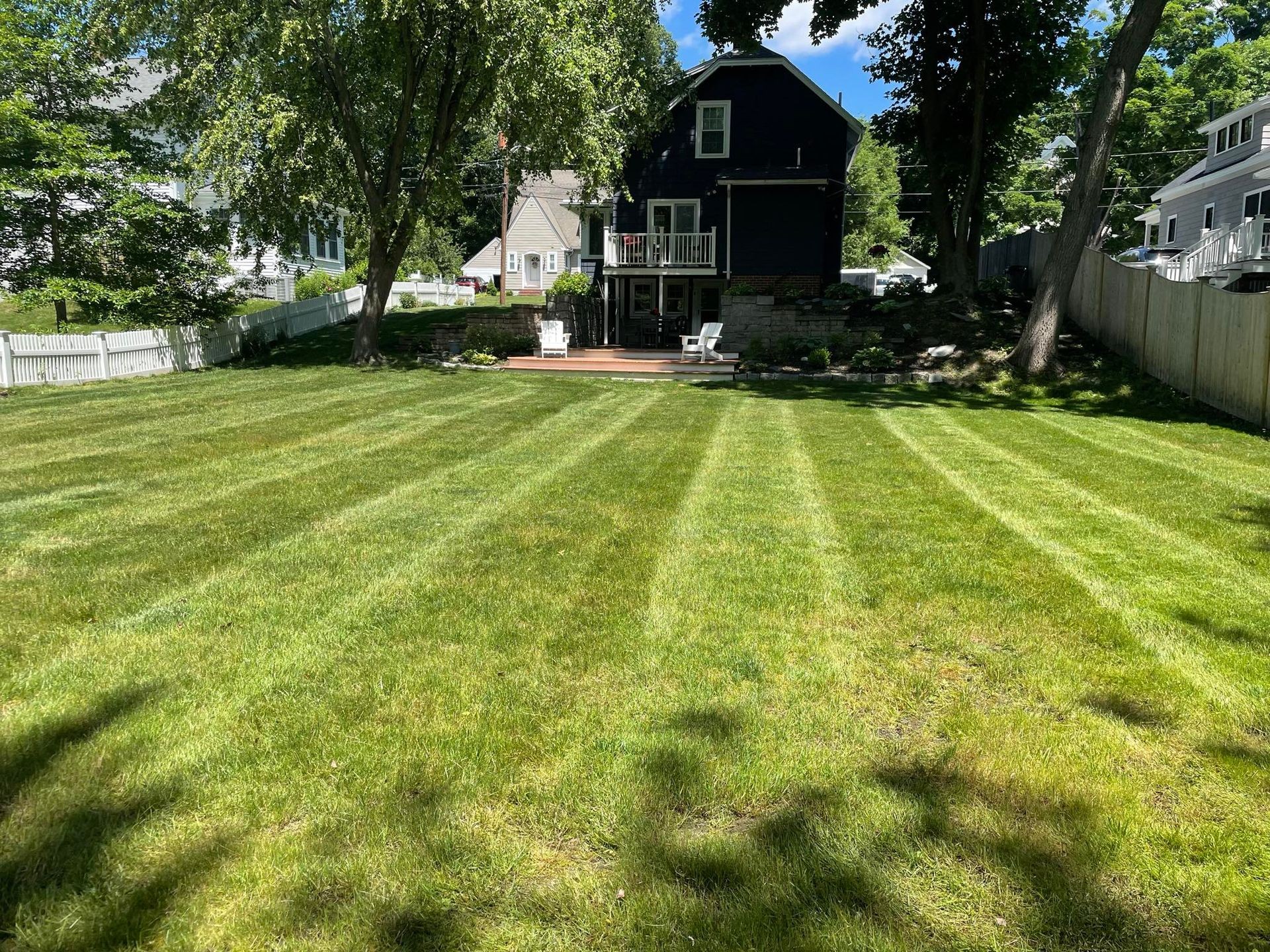 Professional lawn care in Amesbury, MA by Pondhill Greenscapes, featuring mowing, edging, aeration, and sod installation for a pristine yard.